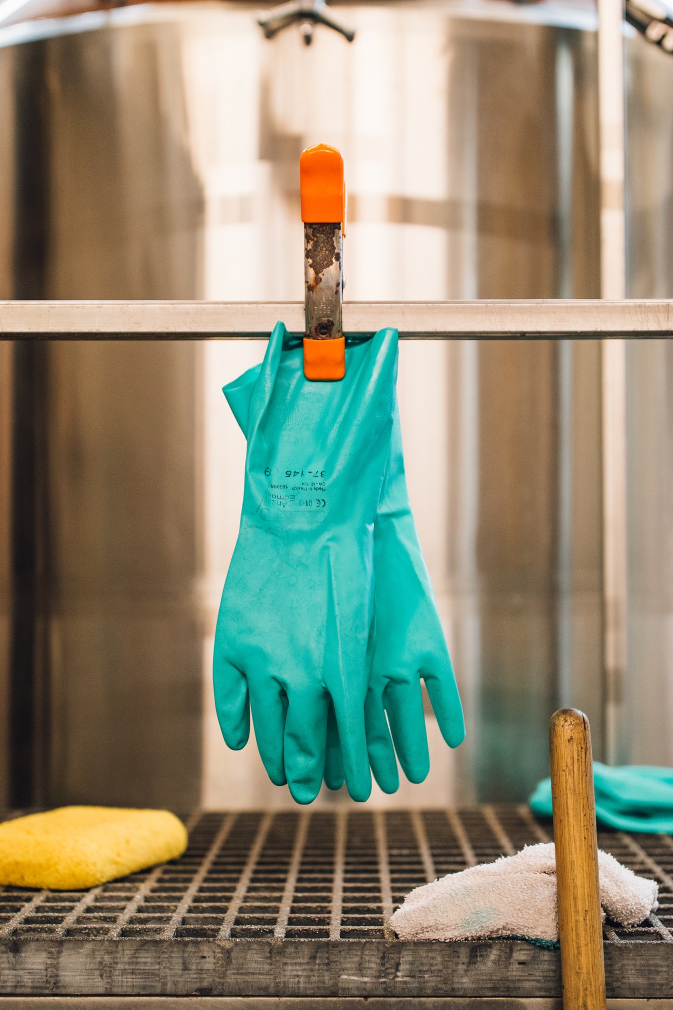 teal turquoise blue rubber gloves in industrial setting